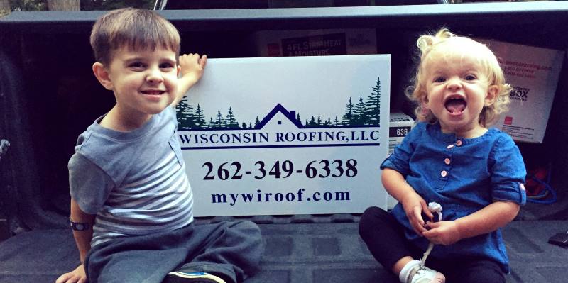 Kids Posing with a Wisconsin Roofing, LLC Yard Sign