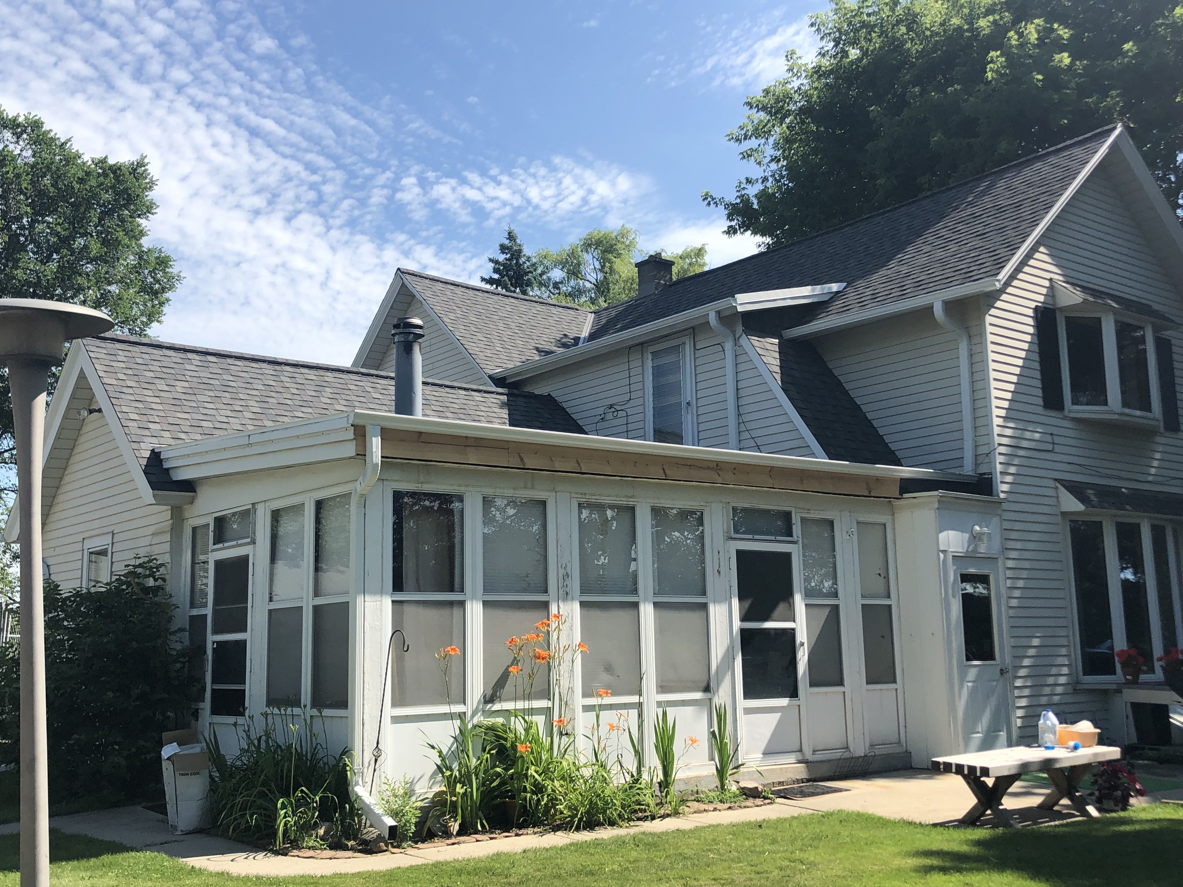 Wisconsin Roofing LLC | Germantown | Residential | New Roof | Added intake and exhaust ventilation difficult farm house | custom transitions | Prior rubber roof done poorly that leaked | Re-framed perimeter